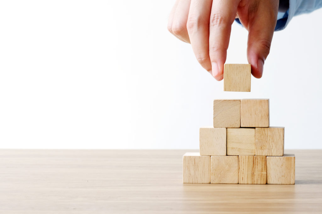 Hand holding blank wooden cubes, business concept background, mock up, template