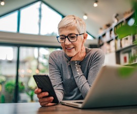 portrait-of-a-cheerful-senior-businesswoman-using-smart-phone-at-home-picture-id1196485602 (1)